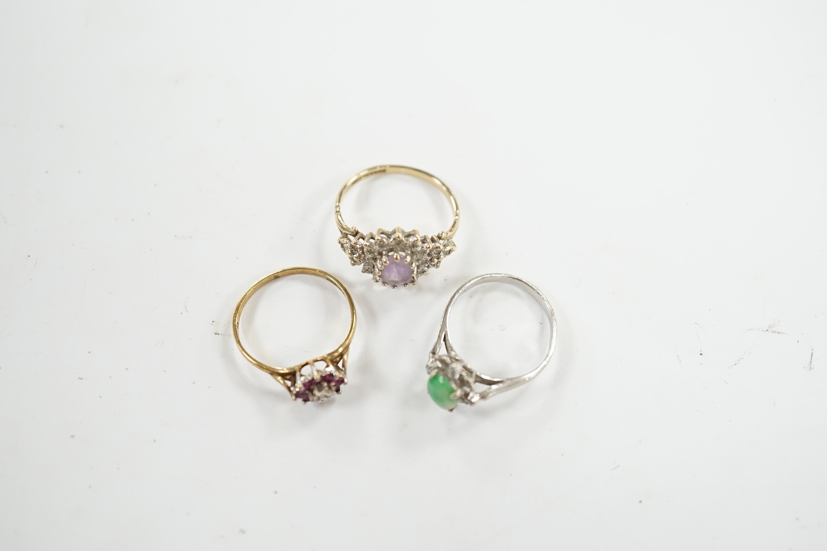 A mid 20th century 18k, jade and diamond cluster set ring, size I, gross weight 1.5 grams, together with two modern 9ct gold and gem set rings, gross weight 3.2 grams. Condition - fair